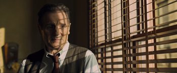 Movie still from “Marlowe” (2022), directed by Neil Jordan – A person wearing a vest and a tie; Close Up shot, Low angle