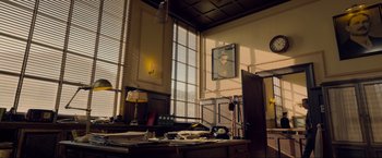 Movie still from “Marlowe” (2022), directed by Neil Jordan – A room with a desk and a picture on the wall; Extreme Wide shot, Low angle