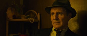 Movie still from “Marlowe” (2022), directed by Neil Jordan – An older man wearing a hat and a suit; Close Up shot, Low angle