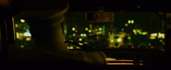 Movie still from “Marlowe” (2022), directed by Neil Jordan – A man looking out of the window of a car at night; Close Up shot, Over the shoulder angle
