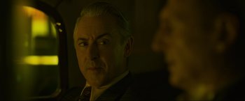 Movie still from “Marlowe” (2022), directed by Neil Jordan – A person wearing a suit and tie; Close Up shot, Over the shoulder angle