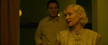 Movie still from “Marlowe” (2022), directed by Neil Jordan – A man and a woman standing next to each other in a room; Close Up shot, Low angle