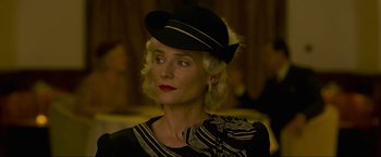 Movie still from “Marlowe” (2022), directed by Neil Jordan – A person wearing a hat; Close Up shot, Low angle