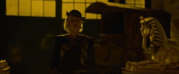 Movie still from “Marlowe” (2022), directed by Neil Jordan – A woman wearing a hat and a tie in the dark; Medium shot, Low angle