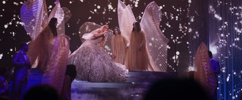 Movie still from “Marry Me” (2022), directed by Kat Coiro – A woman in a dress on a stage; Extreme Wide shot, Low angle