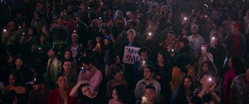 Movie still from “Marry Me” (2022), directed by Kat Coiro – A group of people sitting and standing in a room; Extreme Wide shot, High angle