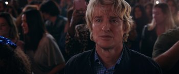 Movie still from “Marry Me” (2022), directed by Kat Coiro – A person wearing a jacket; Close Up shot, Over the shoulder angle