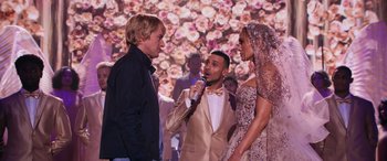 Movie still from “Marry Me” (2022), directed by Kat Coiro – Two men and a woman are talking to each other; Medium shot, Over the shoulder angle