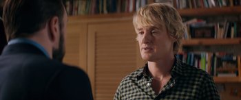 Movie still from “Marry Me” (2022), directed by Kat Coiro – A man with blonde hair and a checkered shirt; Close Up shot, Over the shoulder angle