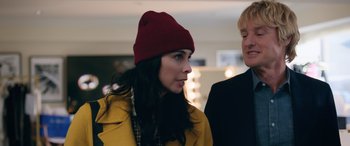 Movie still from “Marry Me” (2022), directed by Kat Coiro – A woman wearing a red hat standing next to another woman; Close Up shot, Over the shoulder angle