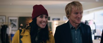 Movie still from “Marry Me” (2022), directed by Kat Coiro – A woman wearing a red hat standing next to a man wearing a black suit; Close Up shot, Over the shoulder angle