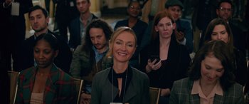 Movie still from “Marry Me” (2022), directed by Kat Coiro – A group of people sitting in front of each other; Medium shot, Over the shoulder angle