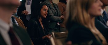 Movie still from “Marry Me” (2022), directed by Kat Coiro – A group of people sitting in a room; Medium shot, Over the shoulder angle