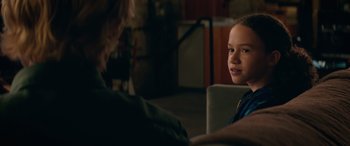 Movie still from “Marry Me” (2022), directed by Kat Coiro – A little girl sitting next to an older person; Close Up shot, Over the shoulder angle