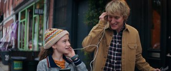 Movie still from “Marry Me” (2022), directed by Kat Coiro – A woman and a boy are listening to music together; Medium shot, Over the shoulder angle