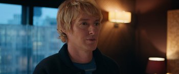 Movie still from “Marry Me” (2022), directed by Kat Coiro – A person with blonde hair; Close Up shot, Over the shoulder angle