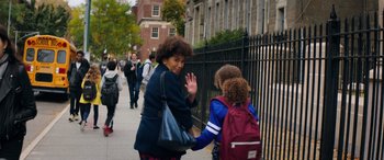 Movie still from “Marry Me” (2022), directed by Kat Coiro – A woman and two children walking down a sidewalk; Medium shot, Over the shoulder angle