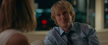 Movie still from “Marry Me” (2022), directed by Kat Coiro – A man sitting in front of a woman in front of a city skyline; Close Up shot, Over the shoulder angle