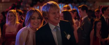 Movie still from “Marry Me” (2022), directed by Kat Coiro – A man and a woman smiling for the camera; Close Up shot, Over the shoulder angle
