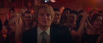 Movie still from “Marry Me” (2022), directed by Kat Coiro – A group of people standing in a room; Close Up shot, Low angle