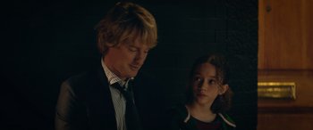 Movie still from “Marry Me” (2022), directed by Kat Coiro – A man and a young girl are standing in a dark room; Close Up shot, Over the shoulder angle