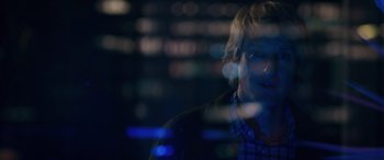 Movie still from “Marry Me” (2022), directed by Kat Coiro – A man is looking at the camera through a glass window; Close Up shot, Over the shoulder angle