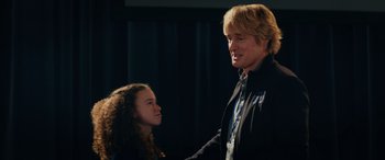 Movie still from “Marry Me” (2022), directed by Kat Coiro – A man and a young girl standing next to each other; Medium shot, Over the shoulder angle
