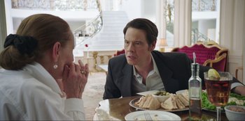 Movie still from “Maximum Truth” (2023), directed by David Stassen – A man and a woman sitting at a table with sandwiches; Medium shot, Over the shoulder angle