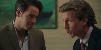 Movie still from “Maximum Truth” (2023), directed by David Stassen – Two men in suits are looking at each other; Close Up shot, Over the shoulder angle