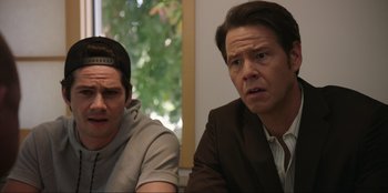 Movie still from “Maximum Truth” (2023), directed by David Stassen – Two men sitting next to each other in front of a window; Close Up shot, Over the shoulder angle