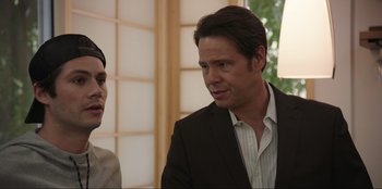 Movie still from “Maximum Truth” (2023), directed by David Stassen – A man in a suit and tie talking to another man in a suit; Close Up shot, Over the shoulder angle