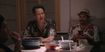 Movie still from “Maximum Truth” (2023), directed by David Stassen – A man sitting at a table with a bowl of soup; Medium shot, Over the shoulder angle
