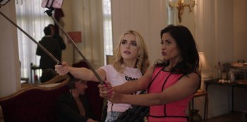 Movie still from “Maximum Truth” (2023), directed by David Stassen – A woman holding a sword in front of another woman; Medium shot, Over the shoulder angle
