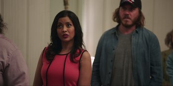 Movie still from “Maximum Truth” (2023), directed by David Stassen – A woman standing next to a man in a room; Medium shot, Over the shoulder angle