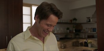 Movie still from “Maximum Truth” (2023), directed by David Stassen – A person wearing a white shirt; Close Up shot, Over the shoulder angle