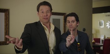 Movie still from “Maximum Truth” (2023), directed by David Stassen – A couple of men standing next to each other; Medium shot, Low angle