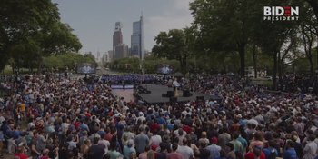 A crowd of people sitting in the grass