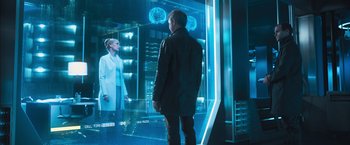 Movie still from “Maze Runner: The Scorch Trials” (2015), directed by Wes Ball – A man standing in front of a large screen; Medium shot, Over the shoulder angle