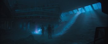 Movie still from “Maze Runner: The Scorch Trials” (2015), directed by Wes Ball – A group of people standing in a dark room; Extreme Wide shot, High angle