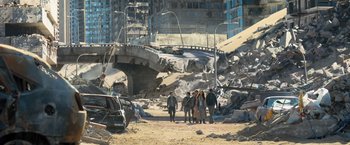 Movie still from “Maze Runner: The Scorch Trials” (2015), directed by Wes Ball – A group of people standing on the side of a road; Extreme Wide shot, High angle