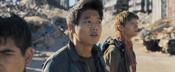 Movie still from “Maze Runner: The Scorch Trials” (2015), directed by Wes Ball – A young man in a black shirt and jacket; Close Up shot, Low angle