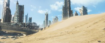 Movie still from “Maze Runner: The Scorch Trials” (2015), directed by Wes Ball – A group of people riding motorcycles on top of a sandy hill; Extreme Wide shot, High angle