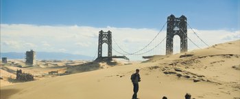 Movie still from “Maze Runner: The Scorch Trials” (2015), directed by Wes Ball – A man standing on top of a sandy beach; Extreme Wide shot, Low angle