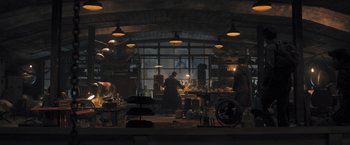 Movie still from “Maze Runner: The Scorch Trials” (2015), directed by Wes Ball – A group of people working in an industrial setting; Wide shot, Low angle