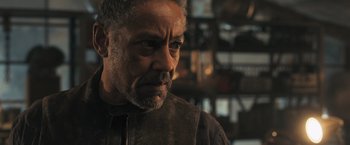 Movie still from “Maze Runner: The Scorch Trials” (2015), directed by Wes Ball – An older man with grey hair looking at the camera; Close Up shot, Over the shoulder angle