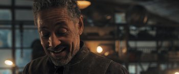 Movie still from “Maze Runner: The Scorch Trials” (2015), directed by Wes Ball – An older man smiling with his eyes closed; Close Up shot, Over the shoulder angle