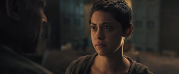 Movie still from “Maze Runner: The Scorch Trials” (2015), directed by Wes Ball – A person with short black hair; Close Up shot, Over the shoulder angle
