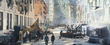 Movie still from “Maze Runner: The Scorch Trials” (2015), directed by Wes Ball – Two men walking down a street near a pile of trash; Extreme Wide shot, High angle