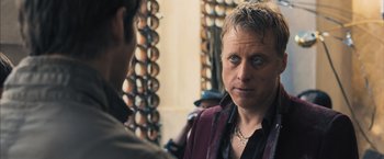 Movie still from “Maze Runner: The Scorch Trials” (2015), directed by Wes Ball – A man in a red jacket talking to another man in a black shirt; Close Up shot, Over the shoulder angle