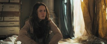 Movie still from “Maze Runner: The Scorch Trials” (2015), directed by Wes Ball – A woman sitting on the ground in front of a window; Close Up shot, Low angle